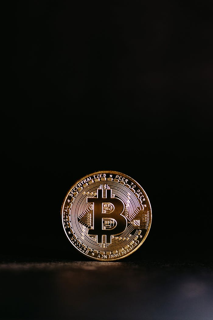 Shiny Bitcoin coin with a black background, symbolizing cryptocurrency's digital value.